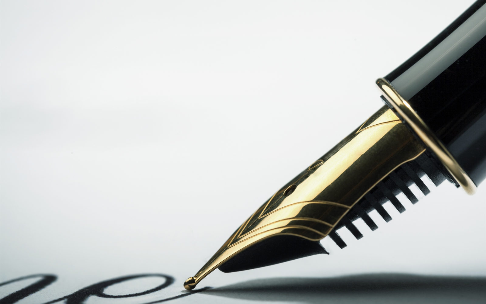 Close-up of a black and gold fountain pen nib signing a document